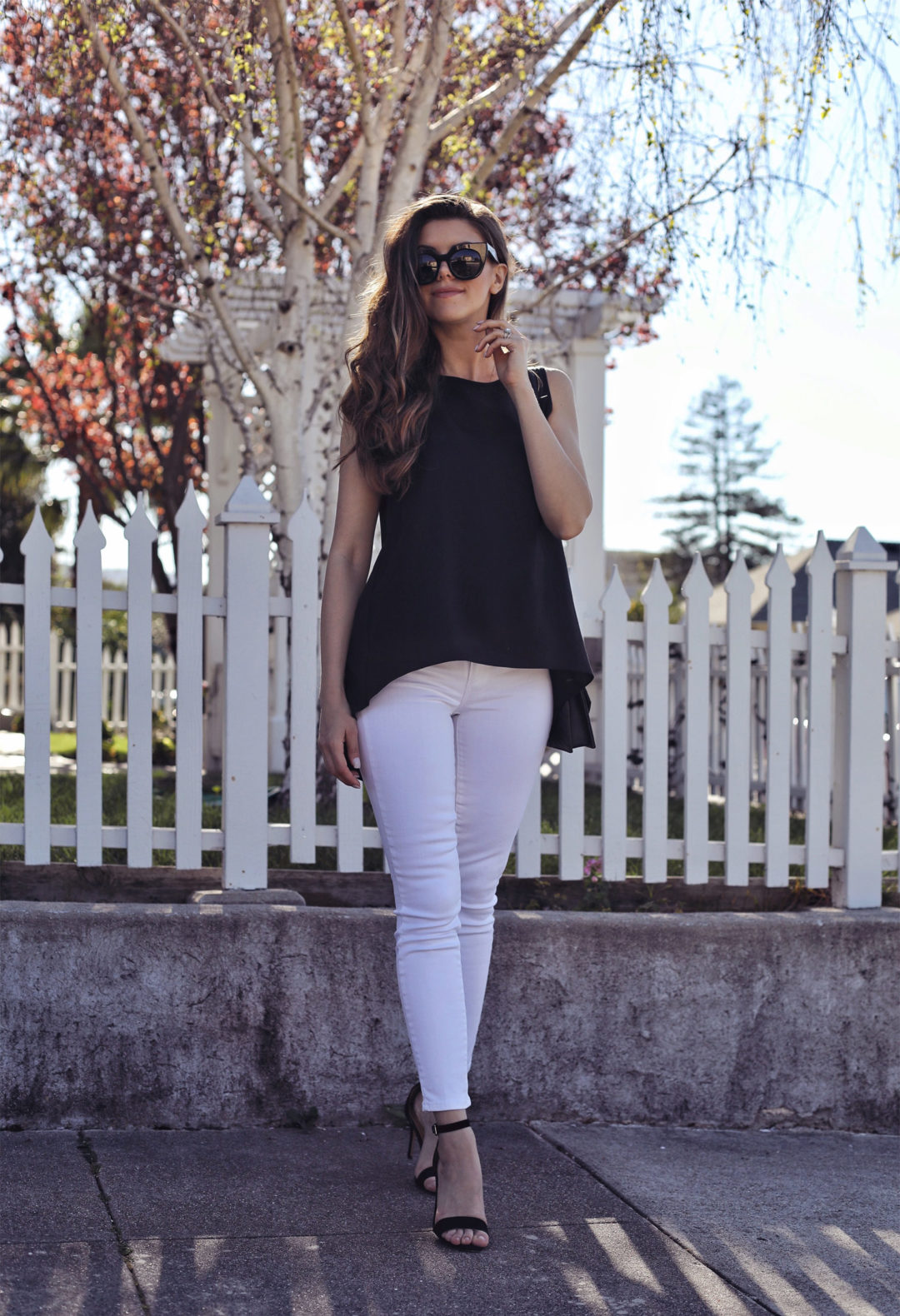 Fashion and lifestyle blogger Adelina Perrin of The Charming Olive wearing Stitch Fix Black Top and White Jeans