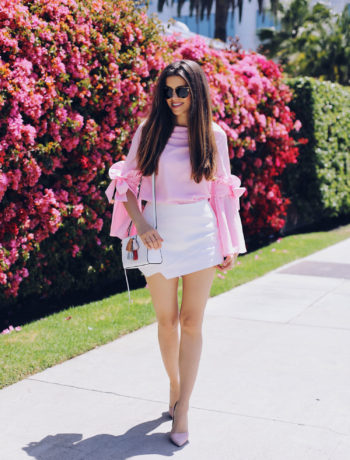 Fashion and lifestyle blogger Adelina Perrin of The Charming Olive wearing Chicwish Pink Top, Revolve White Skorts, Rebecca Minkoff bag