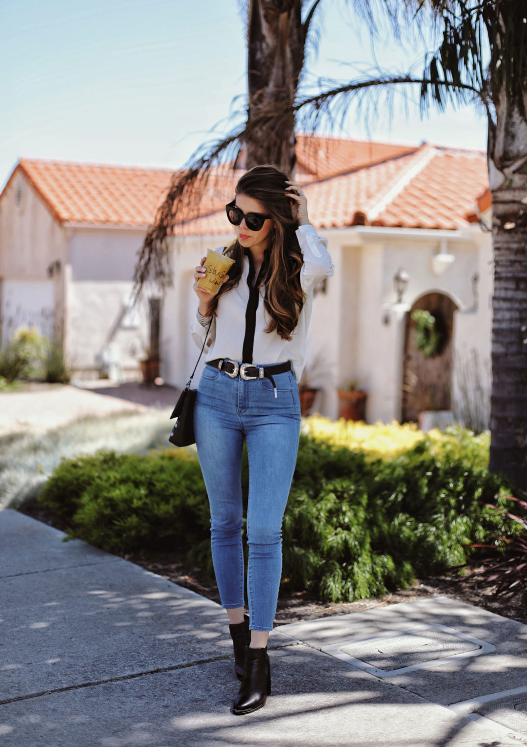 Fashion and lifestyle blogger Adelina Perrin of The Charming Olive wearing Grana Turkish Denim, Grana Silk Shirt, Senso boots and Hammitt Bag