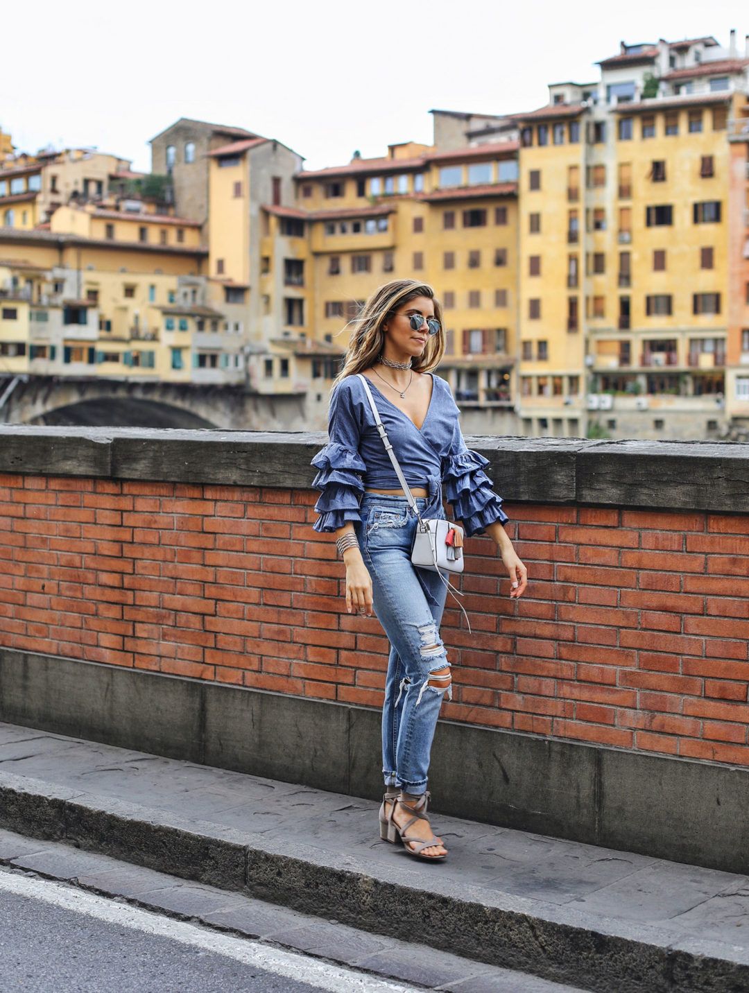Fashion and lifestyle blogger Adelina Perrin of The Charming Olive wearing Tularosa wrap top, Grlfrnd denim jeans and Rebecca Minkoff bag
